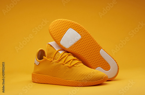 Vászonkép Sport shoes theme in yellow color