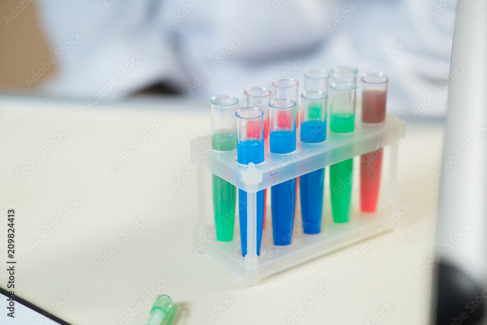 A young man scientist or doctor working with test tubes in lab A young man scientist or doctor working with test tubes in lab