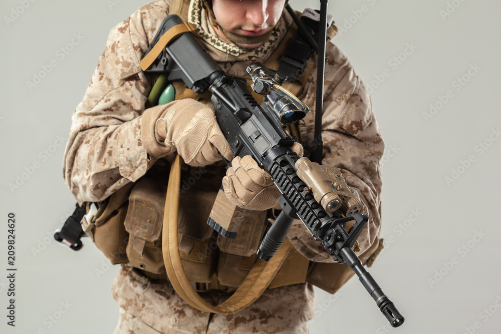 Soldier in camouflage holding rifle Soldier in camouflage holding rifle