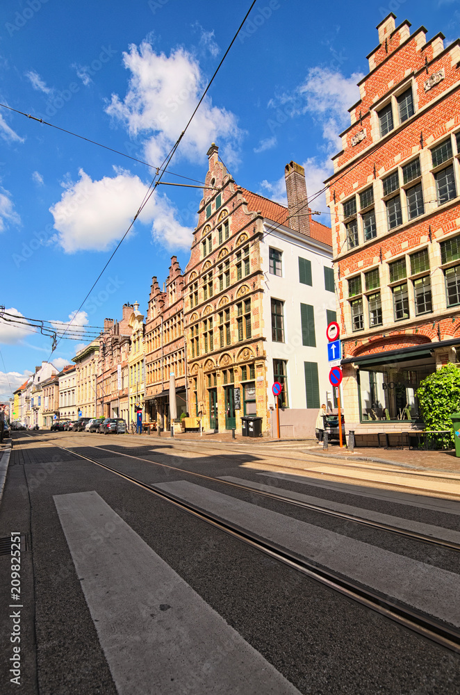 Ghent, Belgium? May 03, 2018: Historical street with buildings in typical Flemish architecture, painted with vivid colors. Spring morning view. Selective focus with wide angle lens