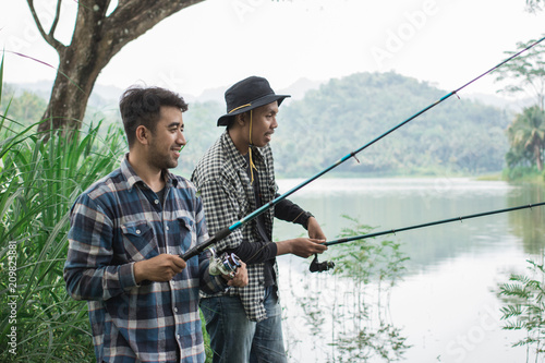 man on the riverbank fishing fish