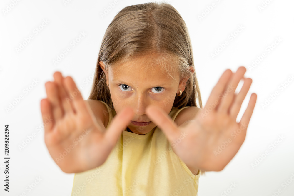 Children violence cute young girl with her hand extended signaling to stop. Children violence cute young girl with her hand extended signaling to stop.