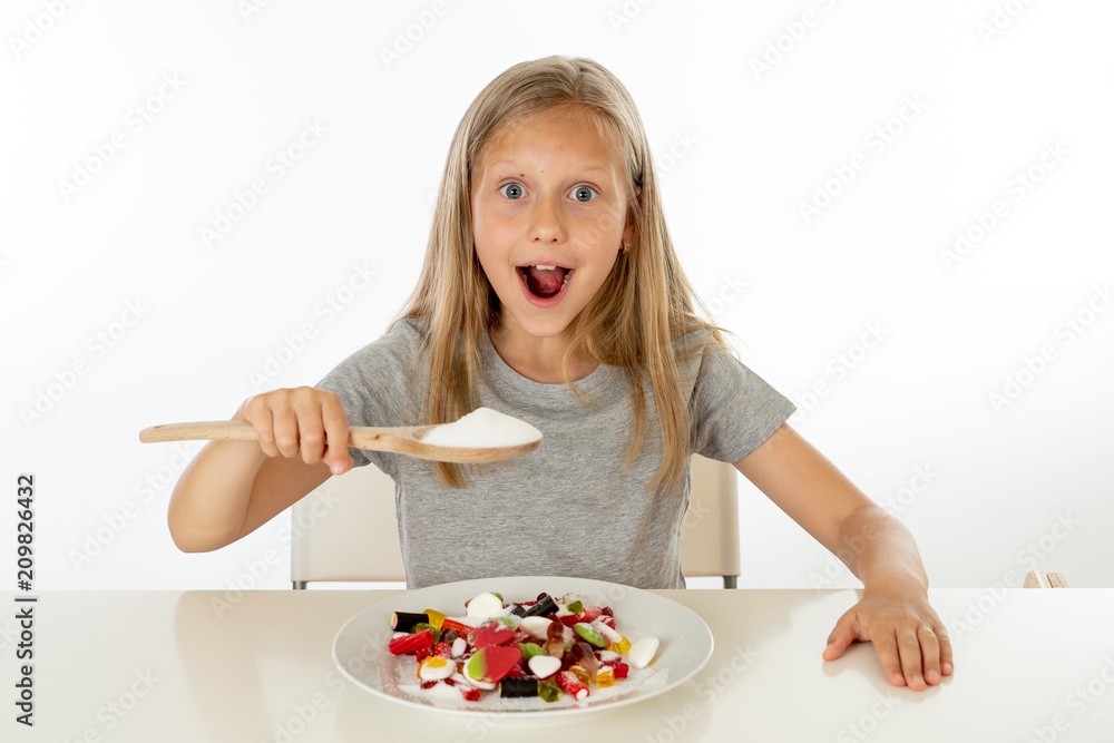 sugar high young blonde girl eating too much sugar in nutrition concept sugar high young blonde girl eating too much sugar in nutrition concept