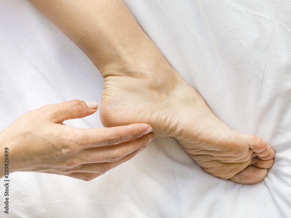 Close up of woman's leg with moisturizing cream.