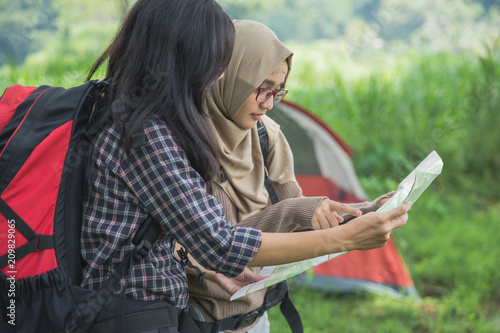 friends hiking in outdoor summer activity using map