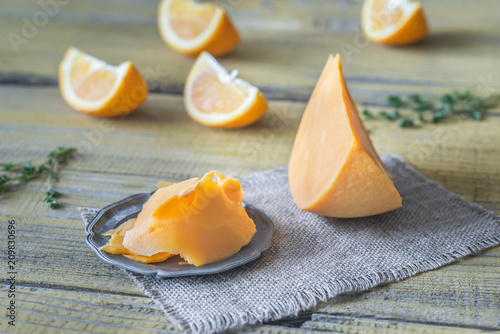 Mimolette cheese on the wooden board