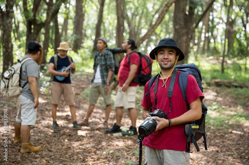 hiker with backpack holding camera © Odua Images
