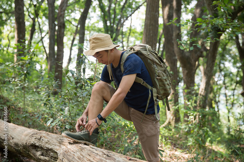 man hiker tying his shoes