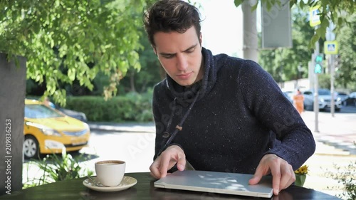 Wallpaper Mural Man Coming and Sitting in Cafe Terrace and Opening on Laptop Torontodigital.ca