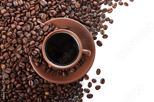Cup of coffee and saucer on background of coffee beans