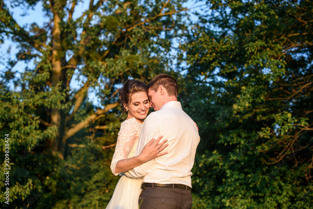 Bridal couple holding each other just after the wedding ceremony.