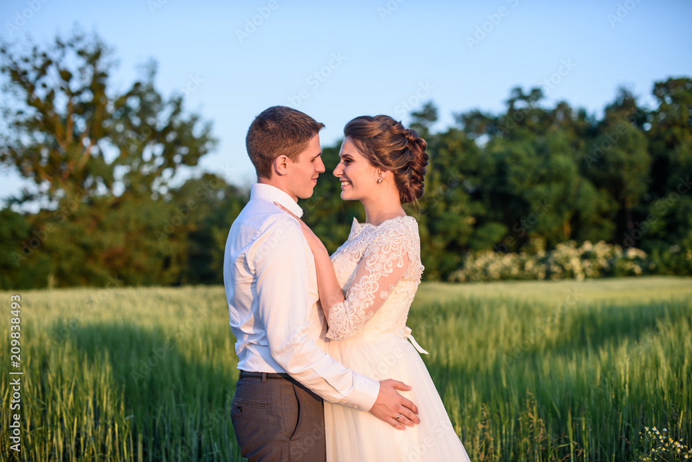 Just married Young romantic couple is hugging and kissing . Attractive woman in wedding dress and handsome man in suit are celebrating wedding day. Honeymoon. Just married Young romantic couple is hugging and kissing . Attractive woman in wedding dress and handsome man in suit are celebrating wedding day. Honeymoon.
