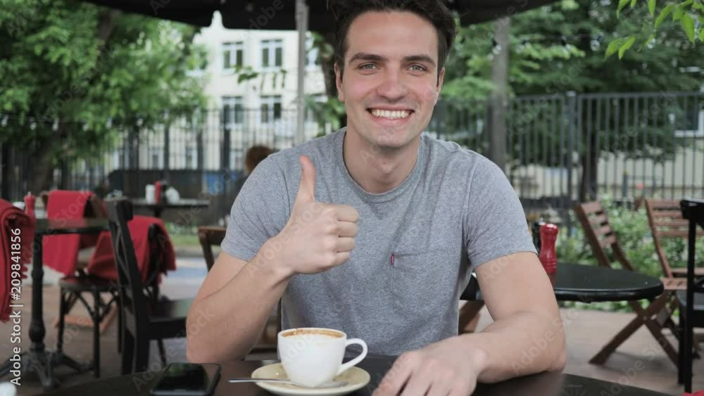 Thumbs Up by Man Sitting in Cafe Terrace Window Thumbs Up by Man Sitting in Cafe Terrace Window
