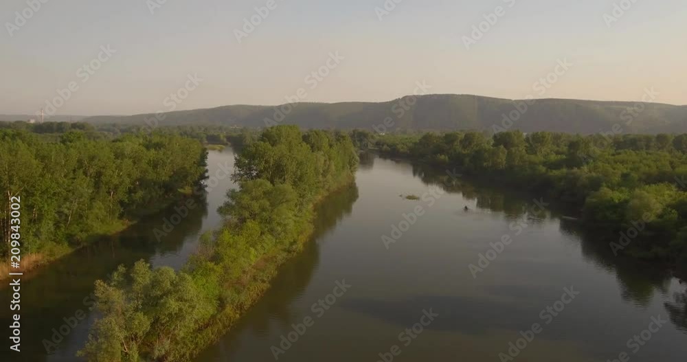 Aerial View. Flying over the beautiful river near small city. Aerial camera shot. Landscape panorama. 4K Aerial View. Flying over the beautiful river near small city. Aerial camera shot. Landscape panorama. 4K