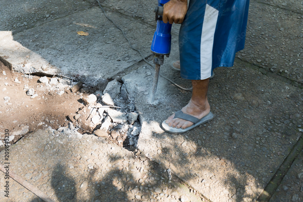 A jackhammer in the hands of an Indonesian A jackhammer in the hands of an Indonesian