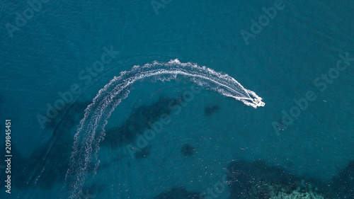 Fotografie, Obraz Aerial view of a white motorboat running on the azure waters of the Tyrrhenian Sea