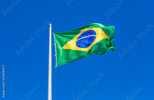 Flag of Brazil flying in the wind against the sky