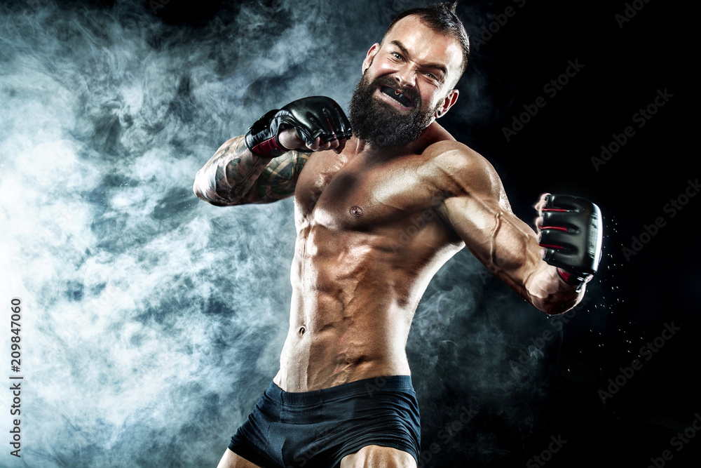 Sportsman boxer fighting on black background with smoke. Copy Space. Boxing sport concept.