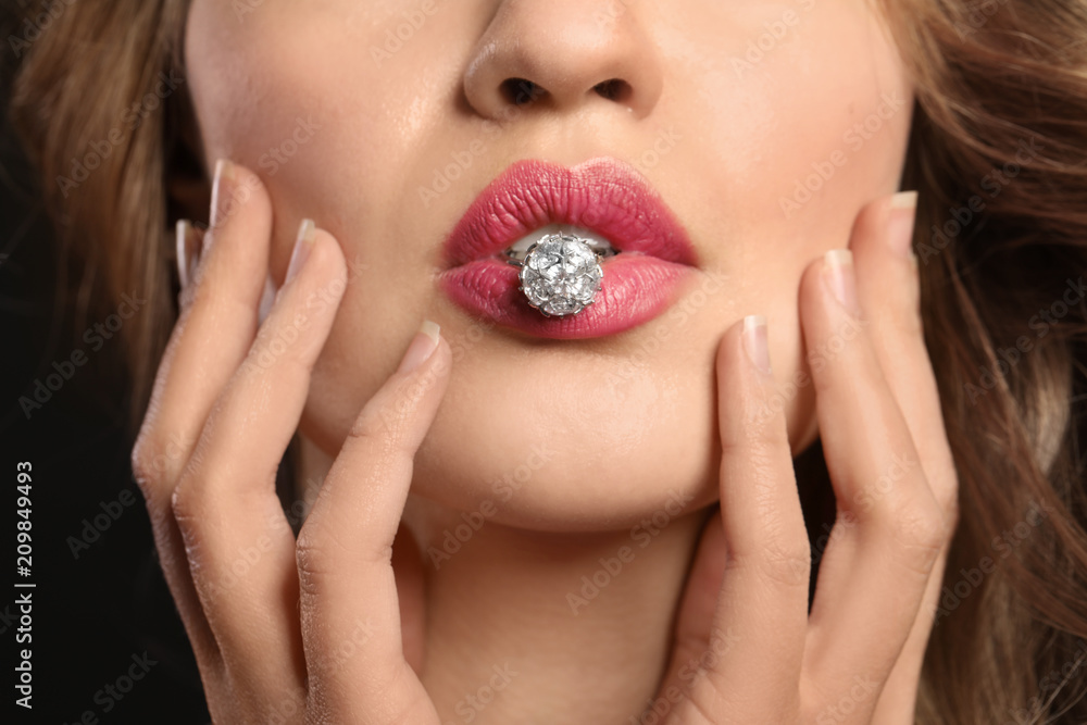 Foto de Young woman with beautiful ring in mouth, closeup do Stock