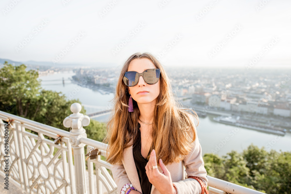 Portrait of a young elegant woman on the beautiful cityscape background traveling in Budapest city