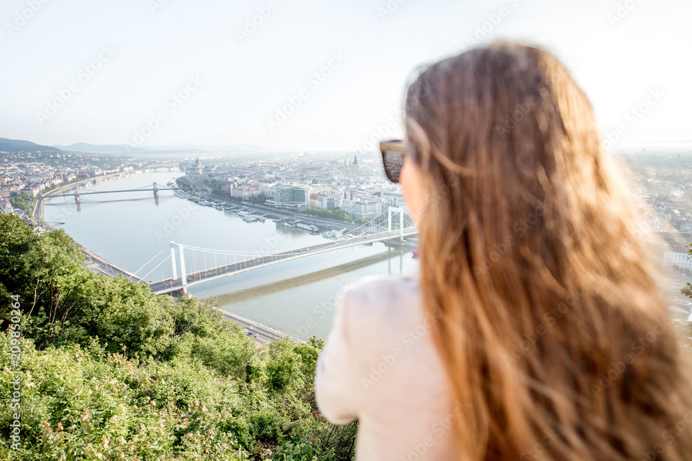 Woman enjoying landscape aerial view on the Budapest city during the morning light in Hungary Woman enjoying landscape aerial view on the Budapest city during the morning light in Hungary
