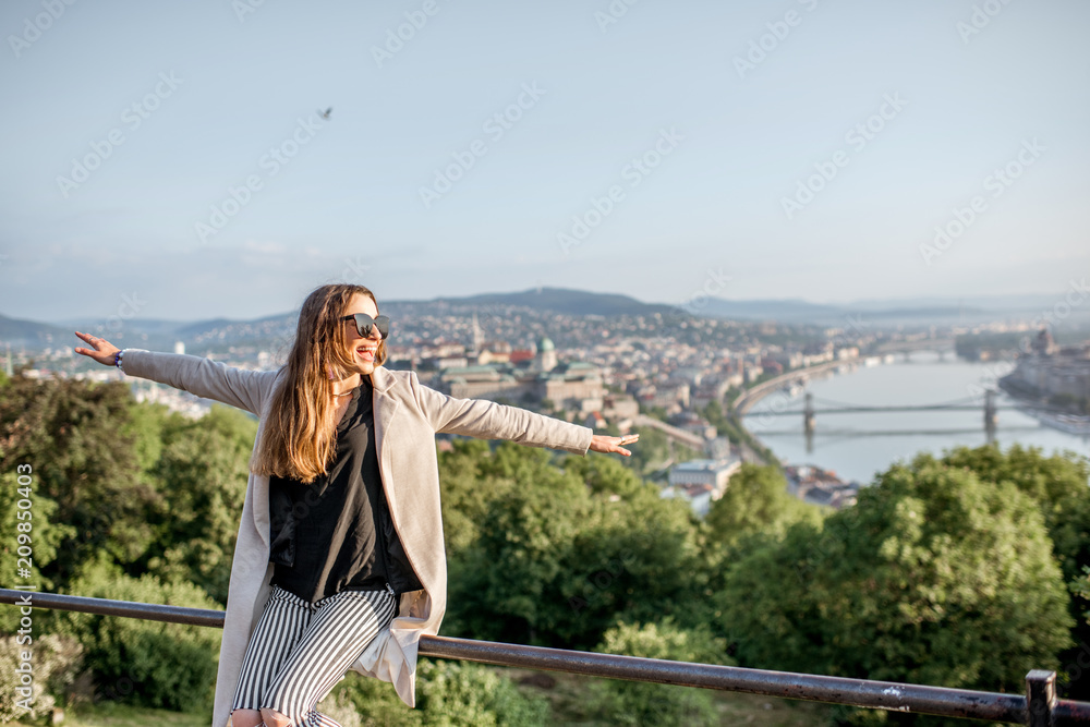 Young woman enjoying beautiful aerial cityscape view on Budapest during the morning light, Hungary