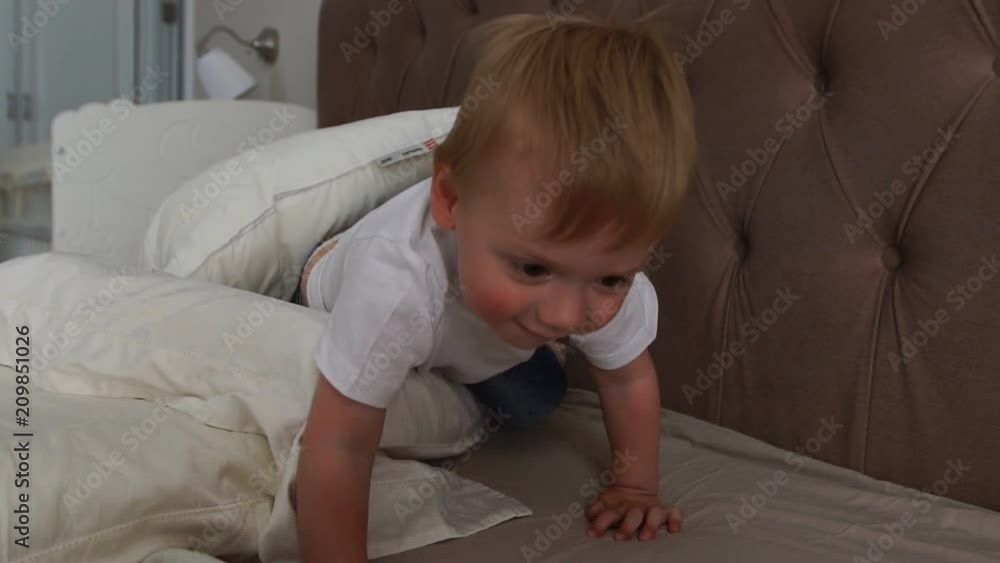 Happy family playing to pillows fight on bed at home Happy family playing to pillows fight on bed at home