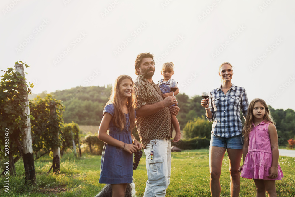 Wine grower family in vineyard before harvesting Wine grower family in vineyard before harvesting