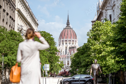 Woman enjoying street view with Parliament building in Budapest city, Hungary