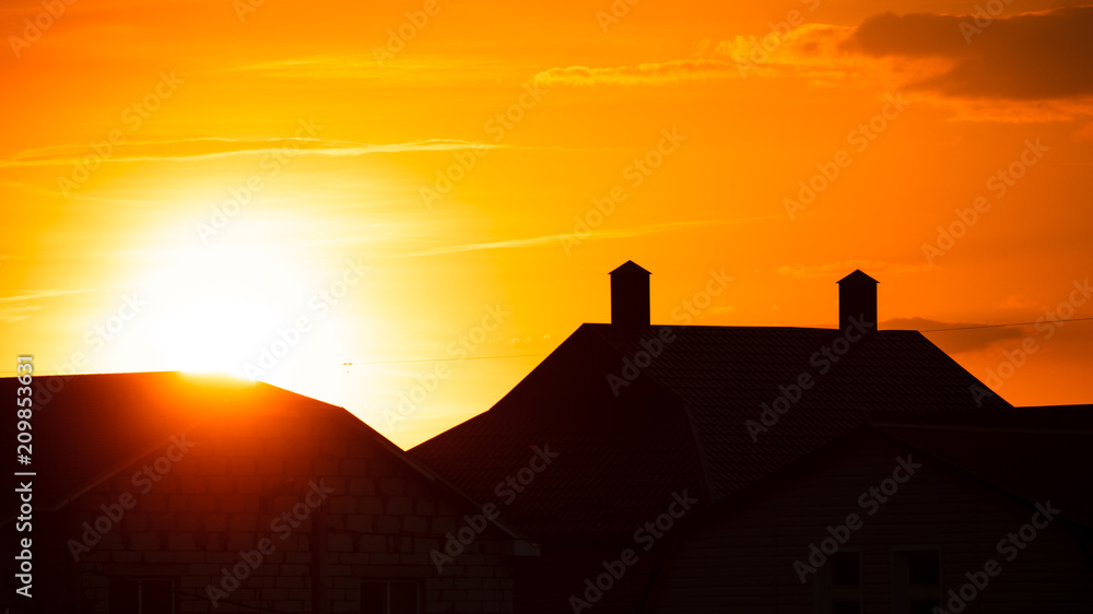 Silhouette of the roof of the house at sunset
