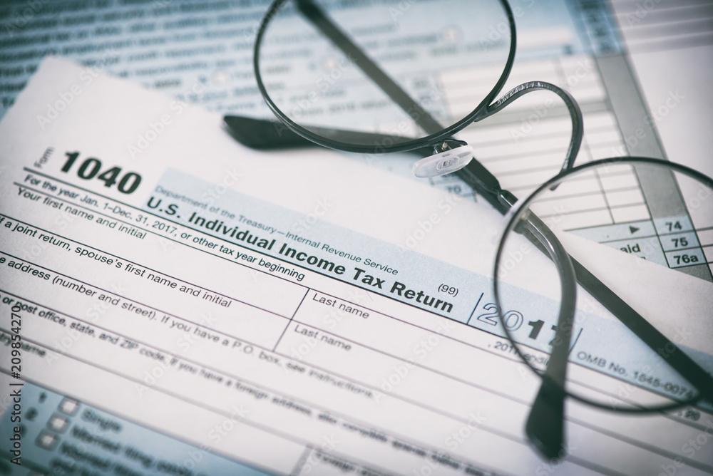 US tax form and glasses. Finance concept US tax form and glasses. Finance concept