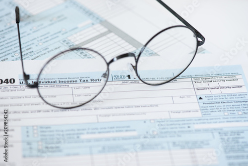US tax form and glasses. Finance concept
