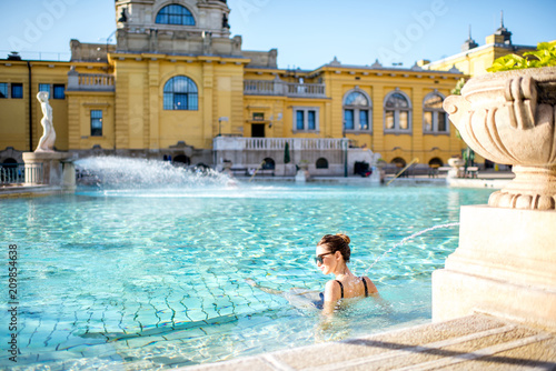 Woman relaxing with water jet massage at the famous Szechenyi thermal bathes in Budapest, Hungary