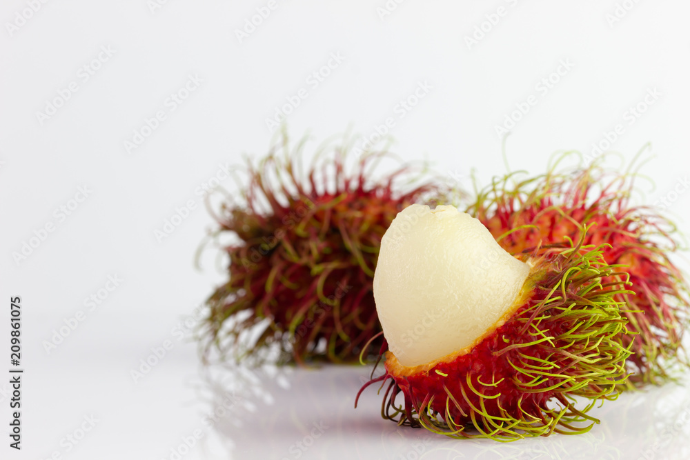 Three rambutans were peeled off on a white background. Three rambutans were peeled off on a white background.