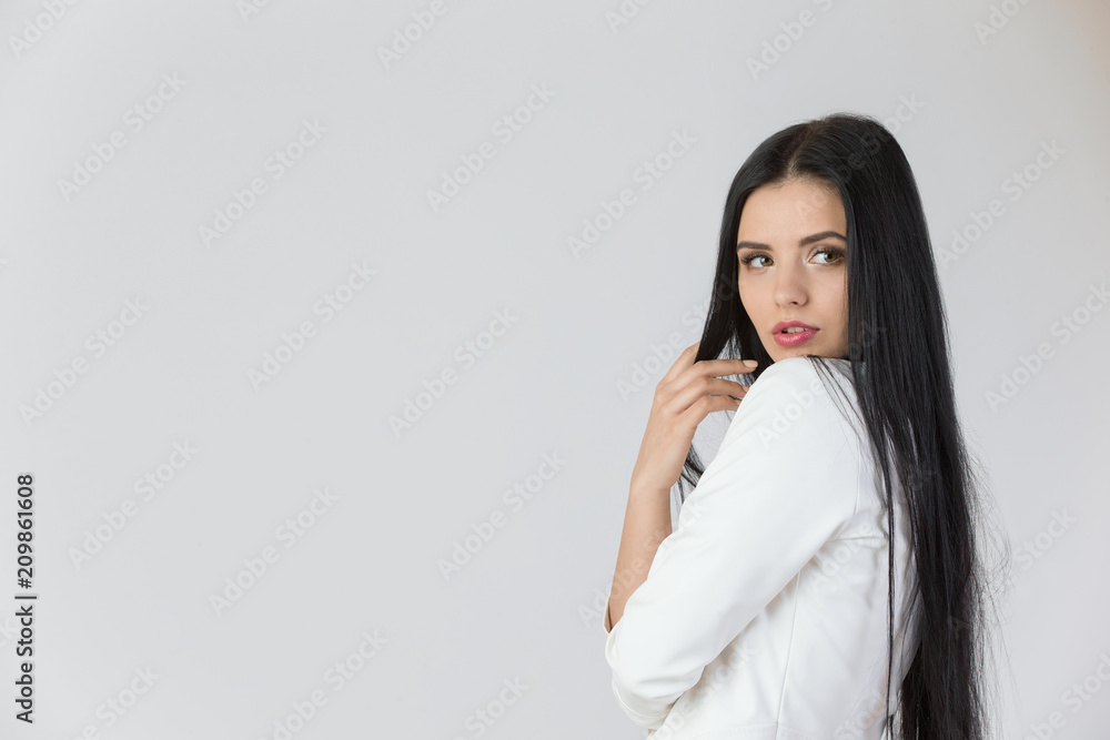 Young beautiful girl with long black hair on isolated white background Young beautiful girl with long black hair on isolated white background