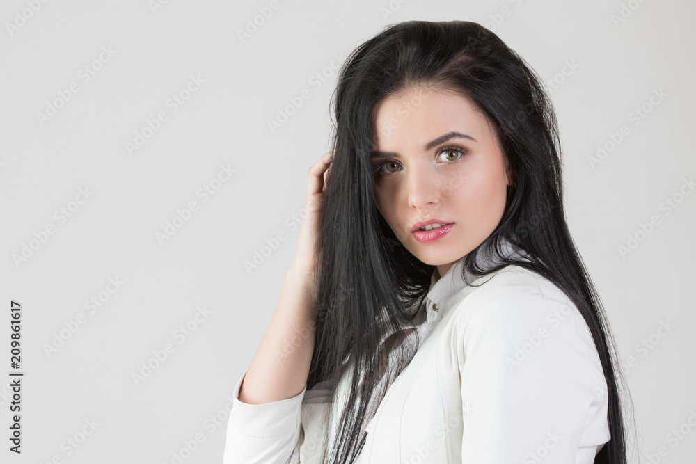 Young beautiful girl with long black hair on isolated white background Young beautiful girl with long black hair on isolated white background