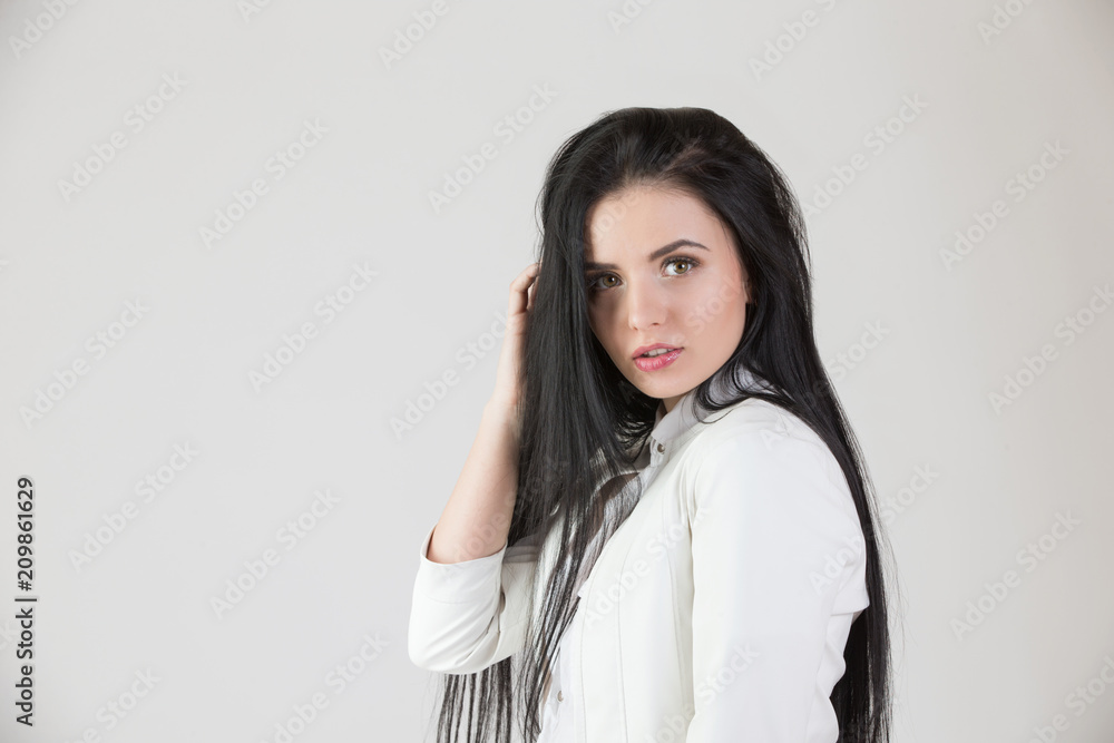 Young beautiful girl with long black hair on isolated white background Young beautiful girl with long black hair on isolated white background