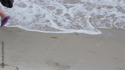 two along the coast along the sea, Woman's Bare Feet and boy Walking At Beach In Sea Foam
