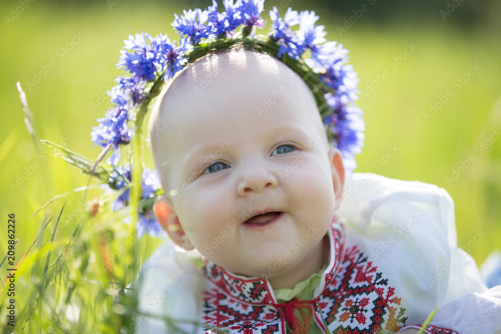 Baby girl with cornflowers in embroidered. Symbol of Belarus Baby girl with cornflowers in embroidered. Symbol of Belarus
