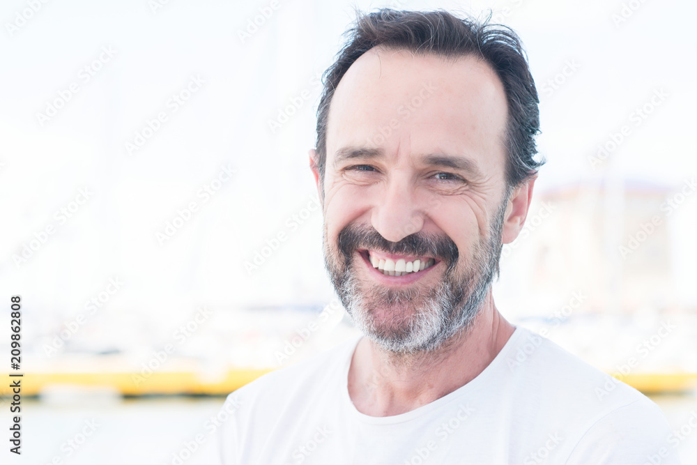 Handsome senior man traveling on sailboat and smiling happy and confident Handsome senior man traveling on sailboat and smiling happy and confident