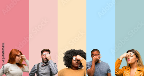 Cool group of people, woman and man with sleepy expression, being overworked and tired, rubbes nose because of weariness