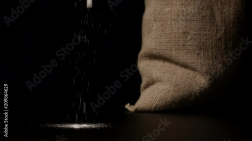 SLOW MOTION: White flour falling down near a sac