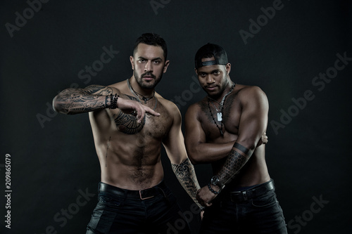 African and hispanic men with sexy bare torso. Men with fit tattooed body. Fashion models with tattoo in jeans. Sportsmen with muscular chest and belly. Sport with fitness and bodycare, vintage filter