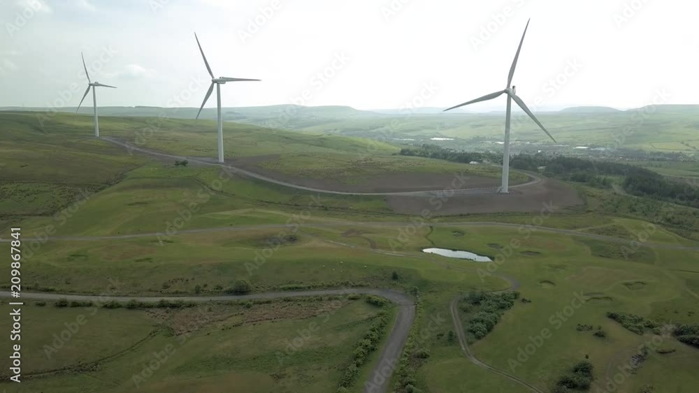 Aerial drone view of large wind turbines on an otherwise unspoilt upland rural landscale (Wales) Aerial drone view of large wind turbines on an otherwise unspoilt upland rural landscale (Wales)