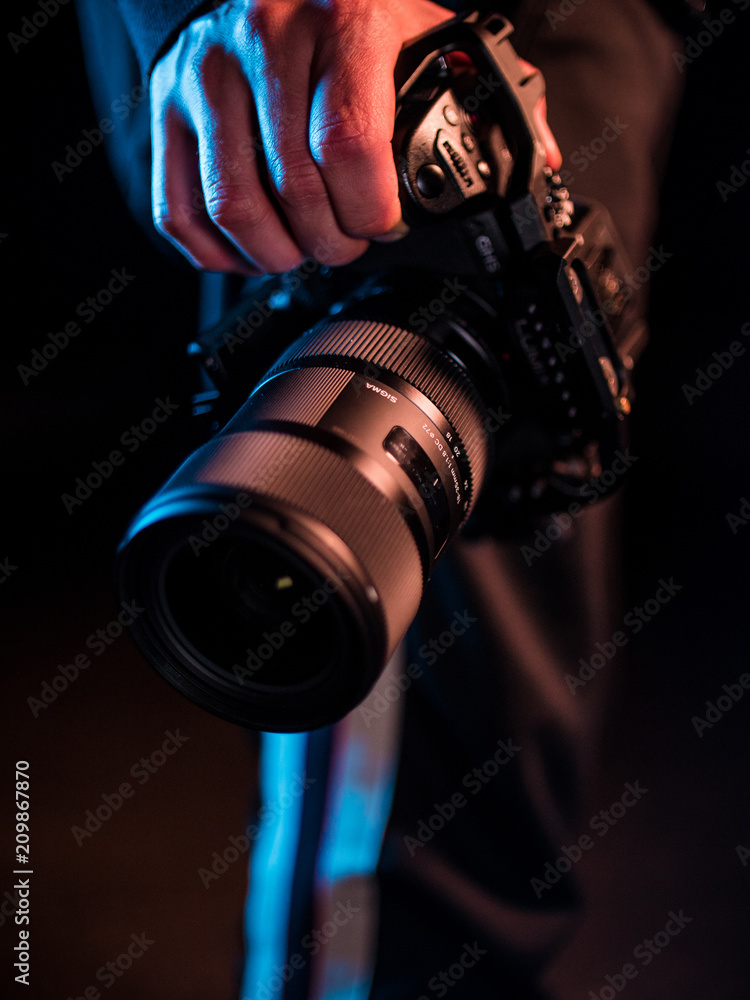 Photographer holding camera in hand