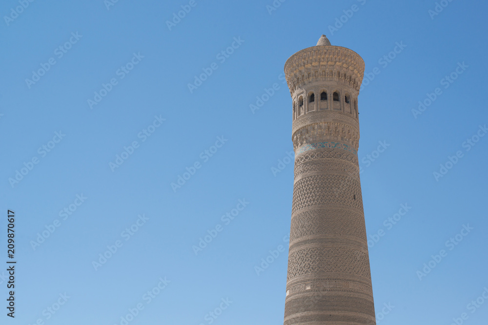 High oval tower of bricks, ancient Asian buildings. the details of the architecture of medieval Central Asia