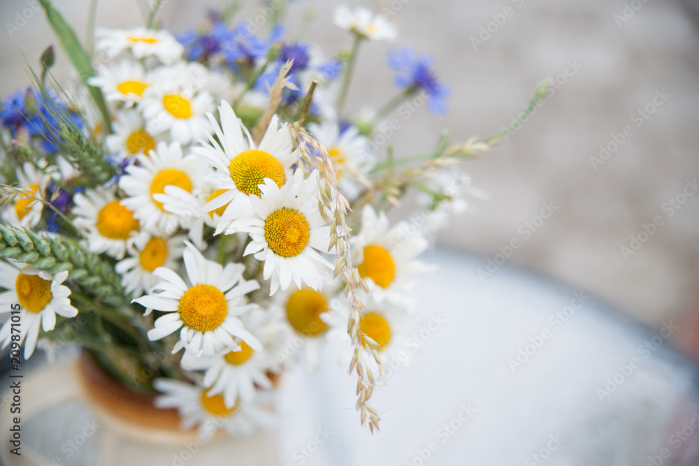 Fototapeta premium Midsummer in Latvia: celebration of Ligo in june decorating home with field flower bouquet