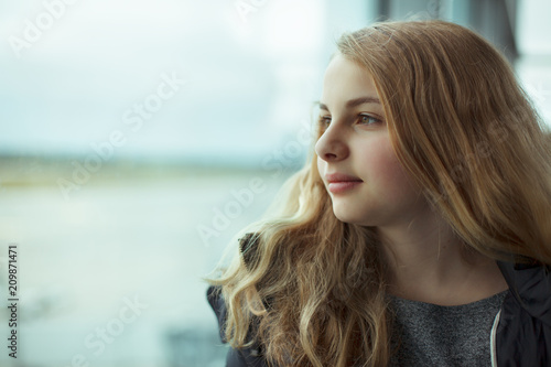 youth girl looking out of a window