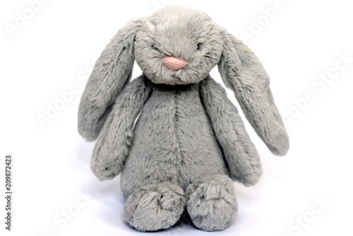 A grey fluffy soft toy rabbit for baby / toddler / child