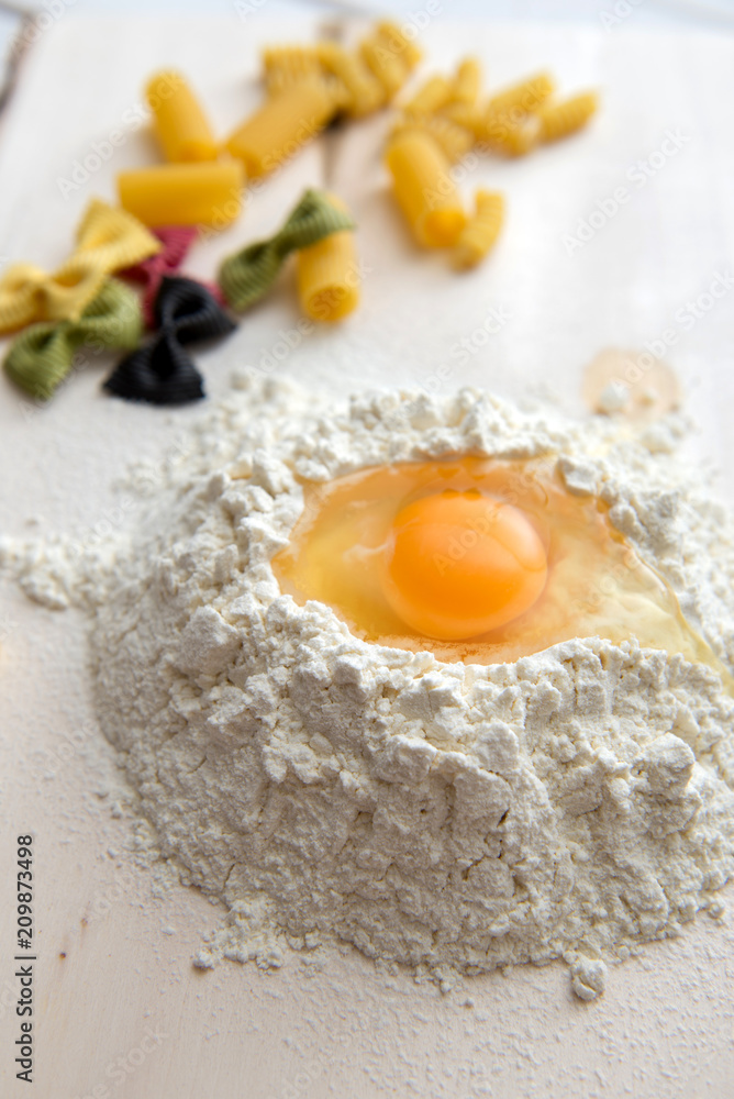 Paste theme. Different kinds of pasta on a wooden background. Farfalle, fettuccine, noodles, fusilli and penne rigate